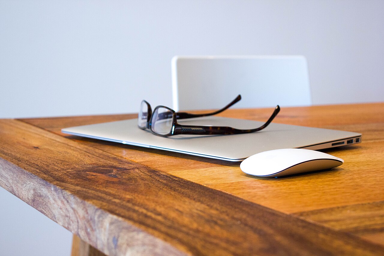 Clean modern desk with a laptop and monitor used for everyday web browsing