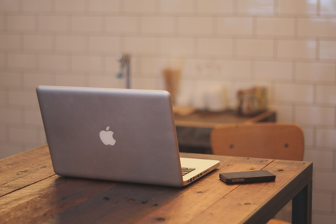 Laptop, smartphone and desk accessories used for daily online tasks